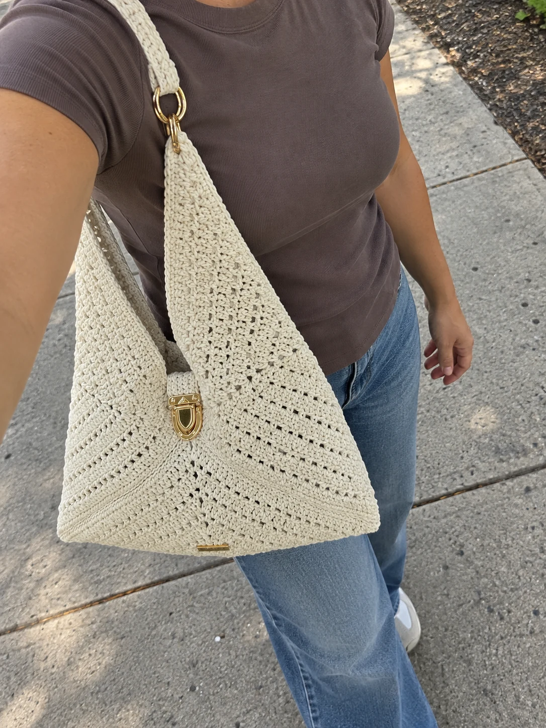 Photo of a cream crochet tote with a long strap and ring detail