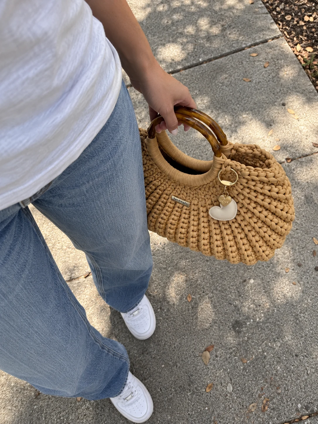 Tan heart-charm crochet handbag